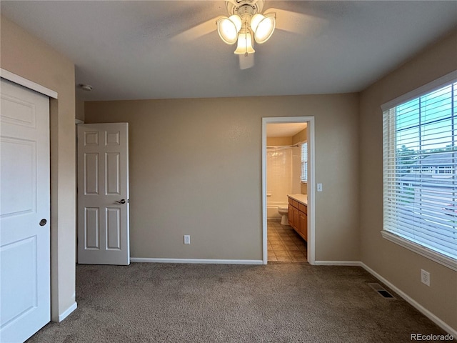 10027 Sylvestor Rd, Highlands Ranch, CO 80129 - unfurnished bedroom featuring carpet, a closet, connected bathroom, and a ceiling fan
