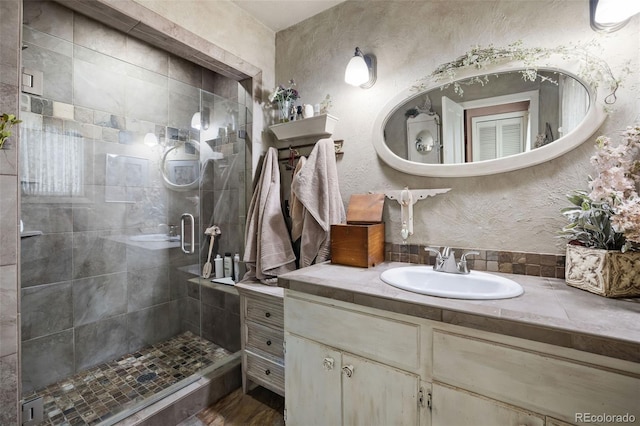 715 Main St, Georgetown, CO 80444 - full bath featuring a shower stall, vanity, and a textured wall