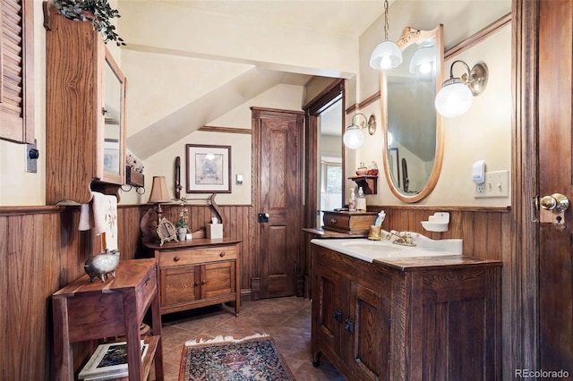 715 Main St, Georgetown, CO 80444 - bathroom with wainscoting, wooden walls, vanity, and tile patterned flooring