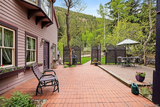 715 Main St, Georgetown, CO 80444 - view of patio / terrace featuring a wooded view and outdoor dining space