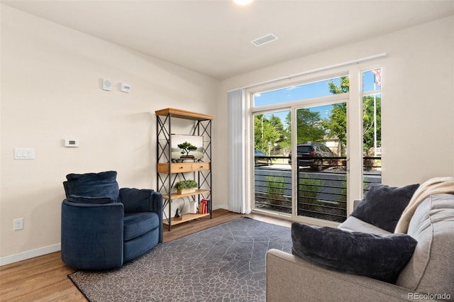 155 S Monaco Pkwy Unit 114, Denver, CO 80224 - sitting room with wood finished floors, visible vents, and baseboards