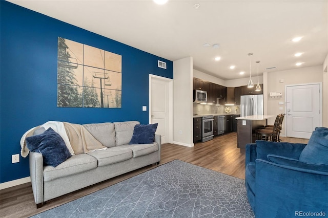155 S Monaco Pkwy Unit 114, Denver, CO 80224 - living area featuring baseboards, recessed lighting, visible vents, and wood finished floors