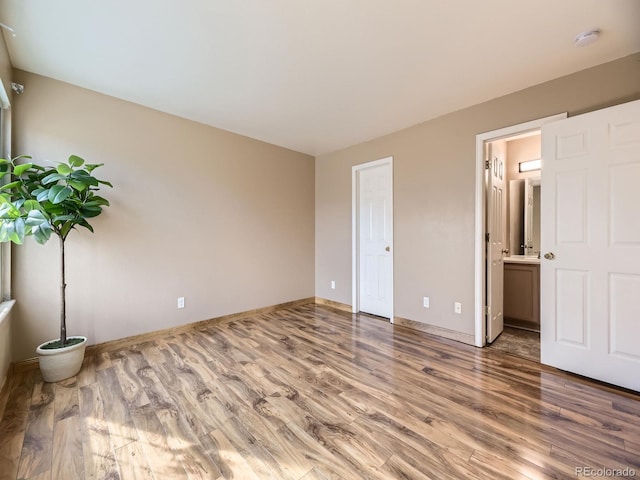 12265 E 2nd Dr, Aurora, CO 80011 - unfurnished bedroom with wood finished floors and connected bathroom