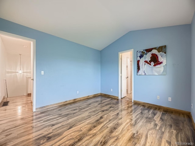 12265 E 2nd Dr, Aurora, CO 80011 - spare room with wood finished floors and lofted ceiling