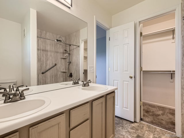12265 E 2nd Dr, Aurora, CO 80011 - bathroom with double vanity,  shower combination, and a walk in closet