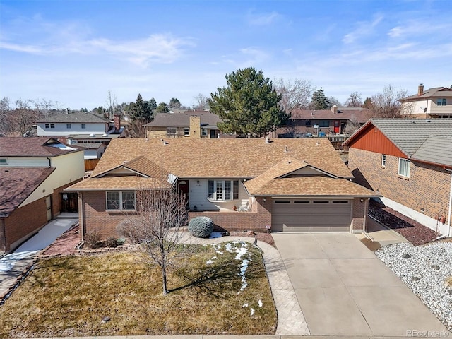 view of front of property featuring a garage, a residential view, concrete driveway, and brick siding