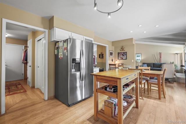 kitchen with light wood-type flooring, white cabinetry, stainless steel fridge with ice dispenser, and recessed lighting