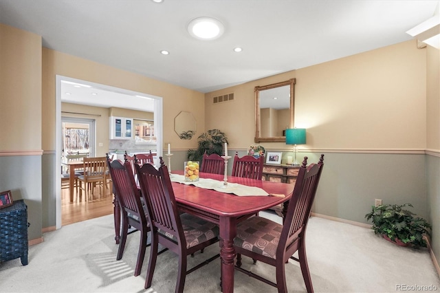 carpeted dining space with recessed lighting, visible vents, and baseboards