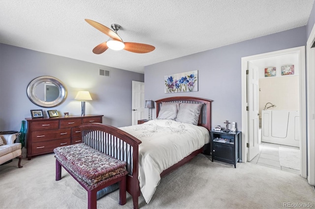 bedroom with a textured ceiling, visible vents, a ceiling fan, and light colored carpet