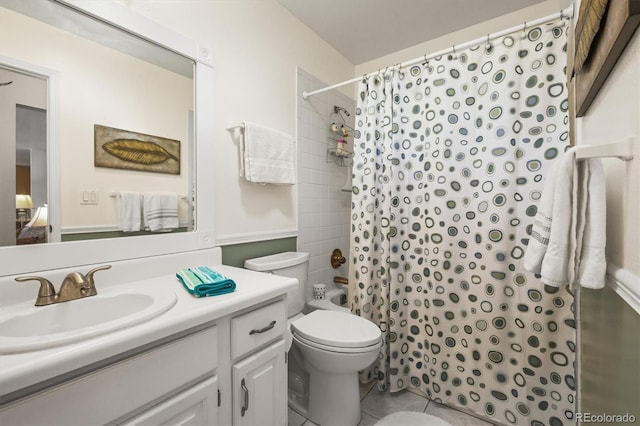 bathroom with shower / bath combination with curtain, tile patterned flooring, vanity, and toilet