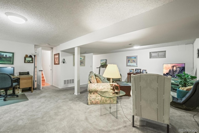 interior space with visible vents, a textured ceiling, and baseboards