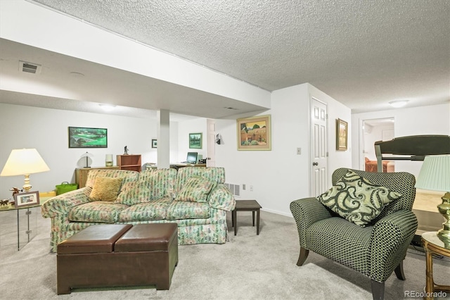 living room with a textured ceiling, carpet, visible vents, and baseboards