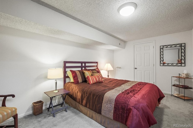 bedroom with carpet floors, a textured ceiling, and baseboards