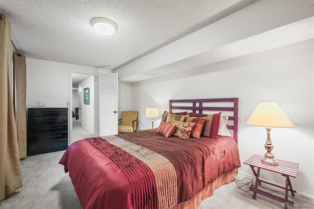 carpeted bedroom with a textured ceiling and baseboards