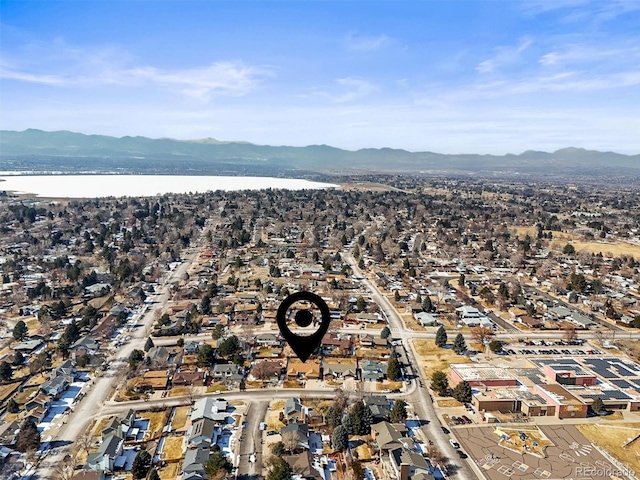 drone / aerial view featuring a residential view and a water and mountain view