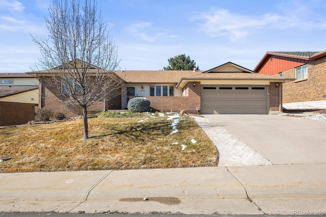 ranch-style home featuring a garage, driveway, and brick siding