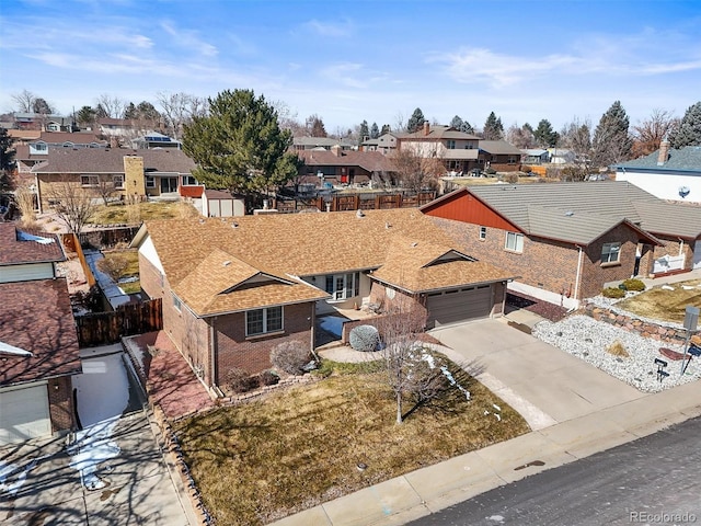 4621 S Perry Way, Denver, CO 80236 - view of front of house featuring a residential view, brick siding, concrete driveway, a shingled roof, and a garage