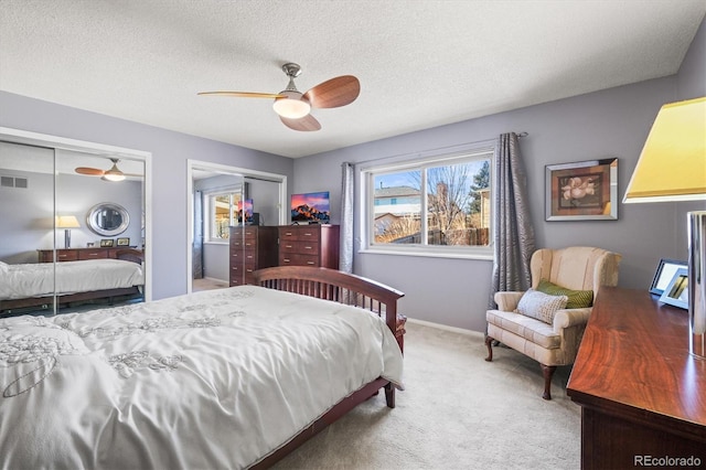 4621 S Perry Way, Denver, CO 80236 - carpeted bedroom with multiple closets, a ceiling fan, and a textured ceiling