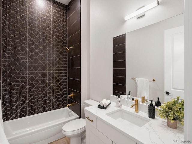 full bathroom featuring vanity, toilet, and tiled shower / bath