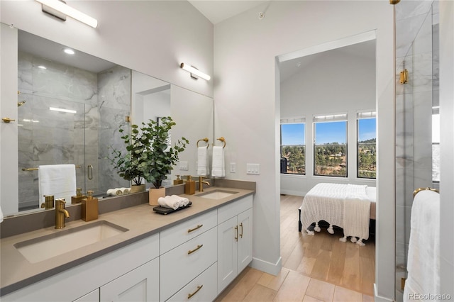 bathroom with walk in shower, hardwood / wood-style floors, vanity, and lofted ceiling