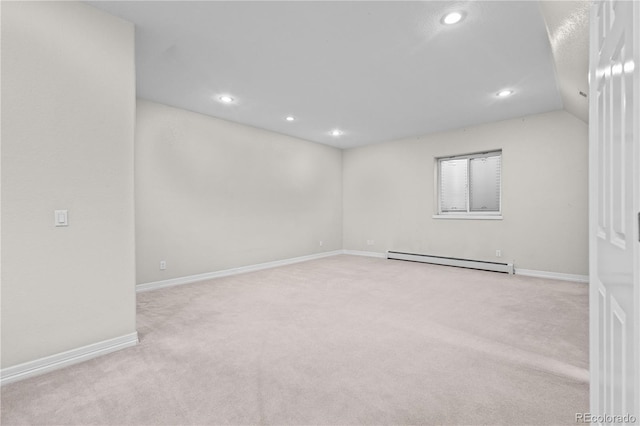 spare room with baseboards, light colored carpet, lofted ceiling, a baseboard radiator, and recessed lighting