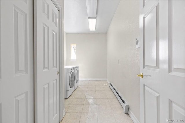 washroom featuring light tile patterned flooring, a baseboard heating unit, laundry area, baseboards, and washing machine and clothes dryer