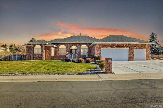 view of front of home with a lawn and a garage