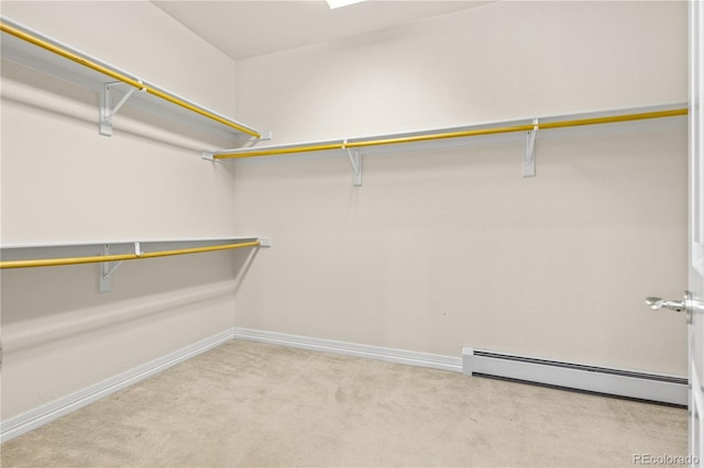 walk in closet featuring light carpet and a baseboard radiator