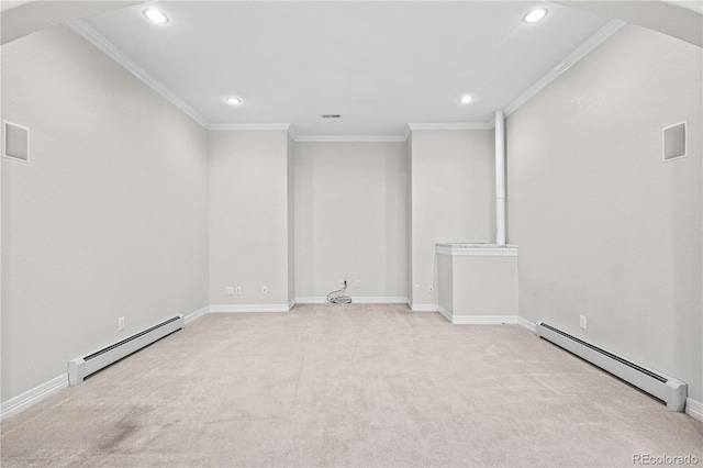 spare room with light carpet, baseboard heating, and crown molding