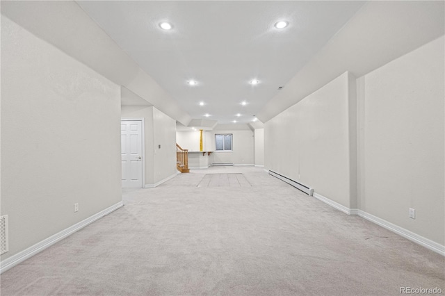 unfurnished living room featuring a baseboard radiator, stairs, baseboards, and recessed lighting