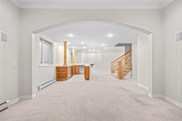 interior space with light carpet, baseboards, baseboard heating, and ornamental molding