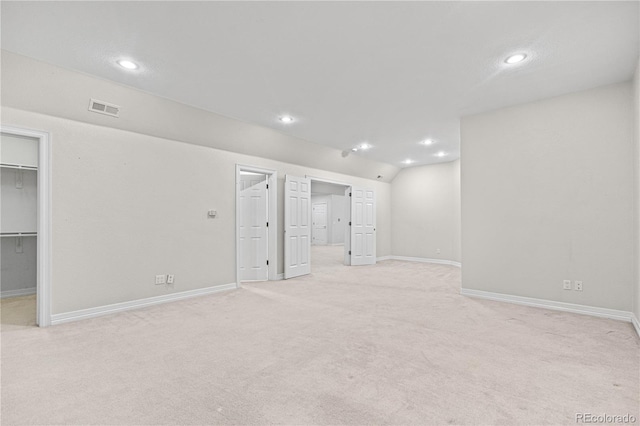 basement with recessed lighting, visible vents, and light colored carpet