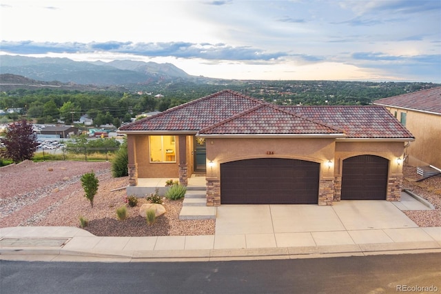 mediterranean / spanish home featuring a mountain view and a garage