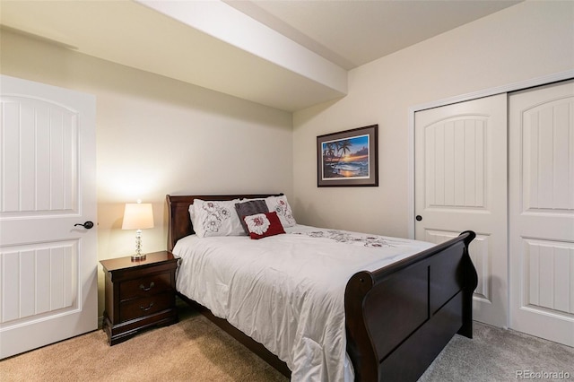 bedroom with light carpet and a closet