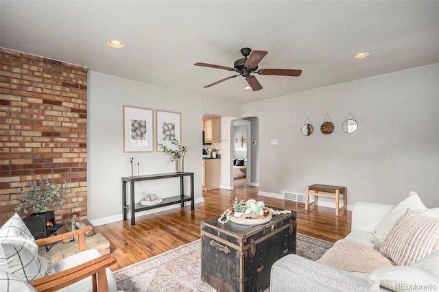 living room featuring wood-type flooring and ceiling fan