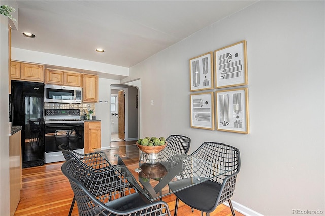 dining space with light wood-type flooring