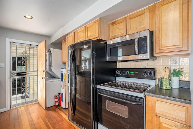 kitchen with light wood-type flooring, electric water heater, black fridge, light brown cabinets, and white electric range oven