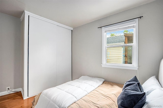 bedroom with hardwood / wood-style flooring