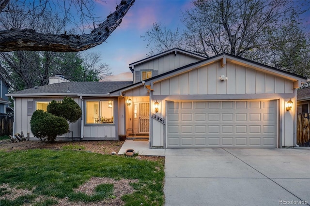 single story home with board and batten siding, driveway, a chimney, a front yard, and a garage