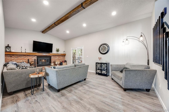 living room with light wood-style floors, recessed lighting, a brick fireplace, and vaulted ceiling with beams