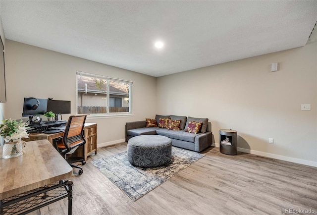 office area featuring baseboards and wood finished floors