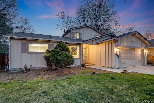 view of front facade with fence, an attached garage, board and batten siding, concrete driveway, and a yard