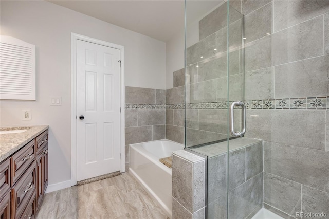 14867 E Pacific Pl, Aurora, CO 80014 - bathroom with vanity, a bath, and a stall shower