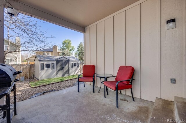 14867 E Pacific Pl, Aurora, CO 80014 - view of patio with a storage unit, grilling area, fence, and an outbuilding