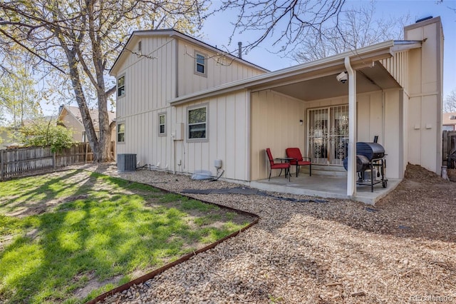 14867 E Pacific Pl, Aurora, CO 80014 - rear view of house featuring a patio, a chimney, fence, a lawn, and board and batten siding