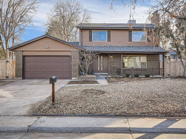 view of property with covered porch and a garage