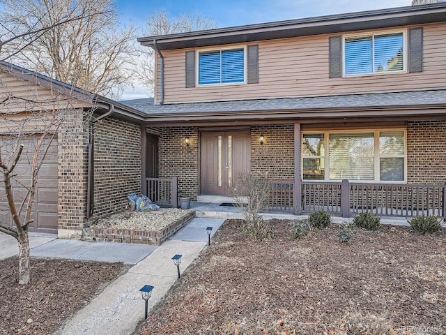 view of front of house featuring a garage and a porch