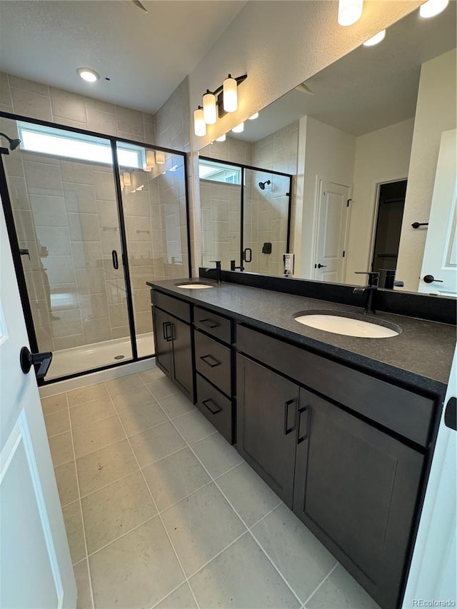 2141 S Irvington St, Aurora, CO 80018 - bathroom featuring double vanity, a shower stall, and tile patterned floors