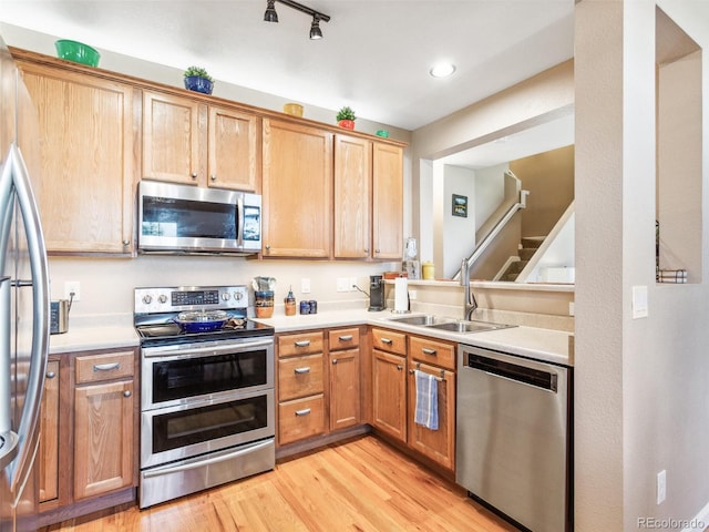 3893 Ute Mountain Trl, Castle Rock, CO 80109 - kitchen with a sink, light countertops, light wood-style floors, stainless steel appliances, and recessed lighting