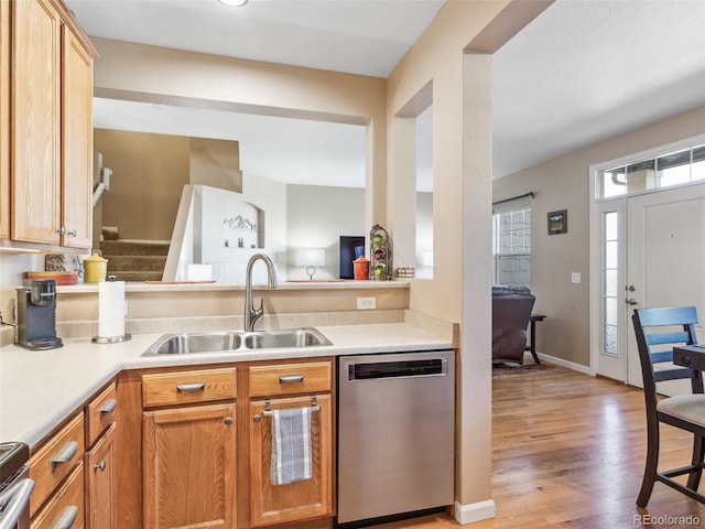 3893 Ute Mountain Trl, Castle Rock, CO 80109 - kitchen with light countertops, light wood-type flooring, a sink, and dishwasher